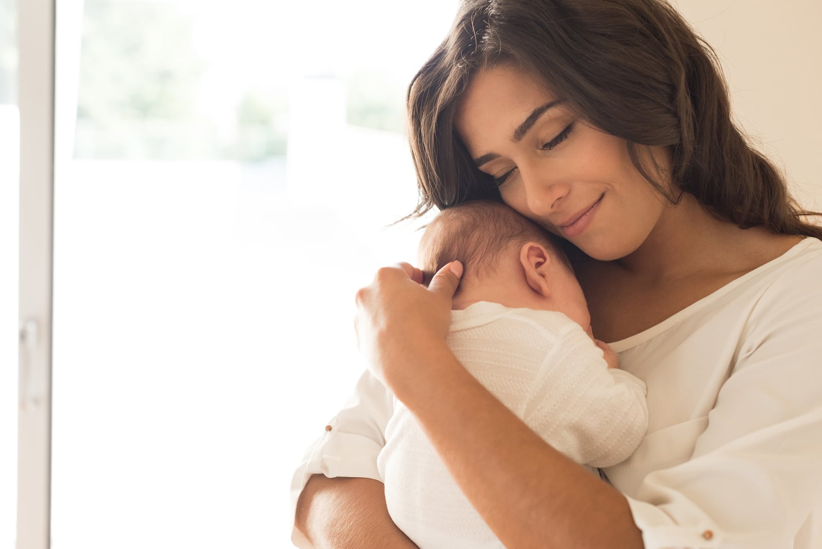 A mother holding her newborn close